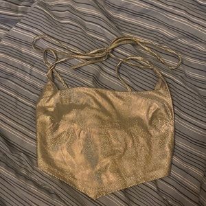 This is holographic fun disco crop top that ties around the neck with straps.